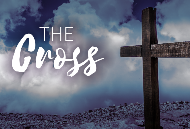Photo of a wooden cross against a sky with clouds. Words read: "The Cross."