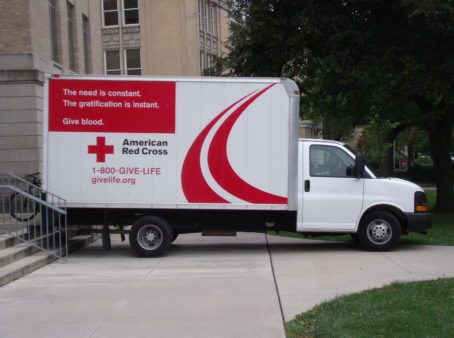 photo of truck next to building. Truck reads "American Red Cross."